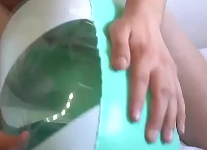 Playing with a Green and White Swimring