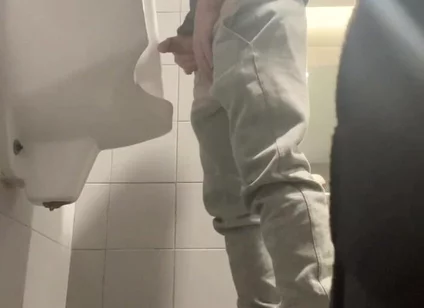 2 Boys in Sneakers Having Fun at Public Toilets' Urinal