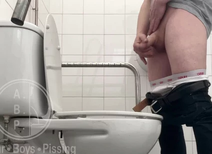 In the Hospital Toilets, a Guy Pisses Into a Cup for a Urine Sample, Then Gets Horny, Jerks-off and Cums