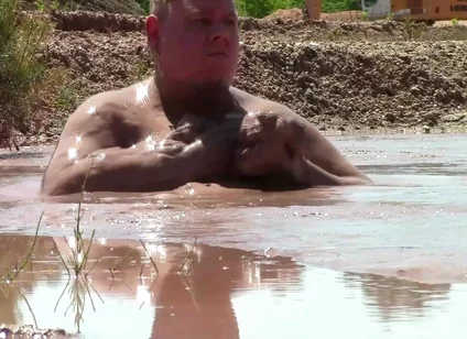 Deep, Creamy Brown Mud Bath in a Sand Pit