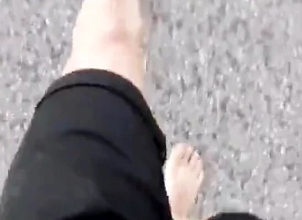 Jon Arteen Walks Barefoot on the Street Outdoors, the Boy Is Barefoot in the Crowded Tram to the Town Center