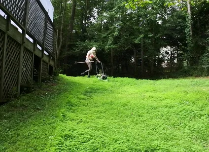 Big Fake Tits Crossdresser in Daisy Dukes Mowing Grass