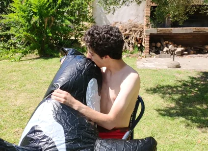 Beautiful Man Inflates His Inflatable Whale Near Pool Outside