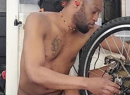 Kennie Jai Does a Nude Bike Repair. Watch That Big Dick Swing!