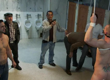 The Wrestler Gets Gang Banged by a Horny Crowd in a Public Restroom for Losing His Match.